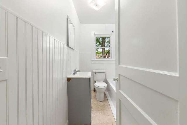 full bathroom with toilet, a bathing tub, and vanity