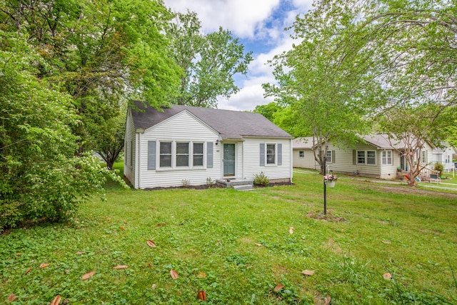 bungalow-style house with a front yard