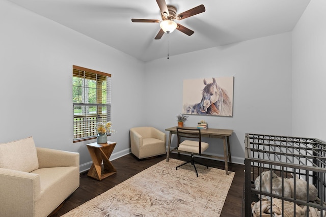 living area featuring an upstairs landing, a ceiling fan, dark wood-style floors, and baseboards