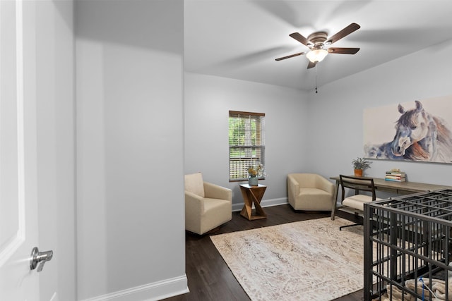 office featuring dark wood-style floors, a ceiling fan, and baseboards