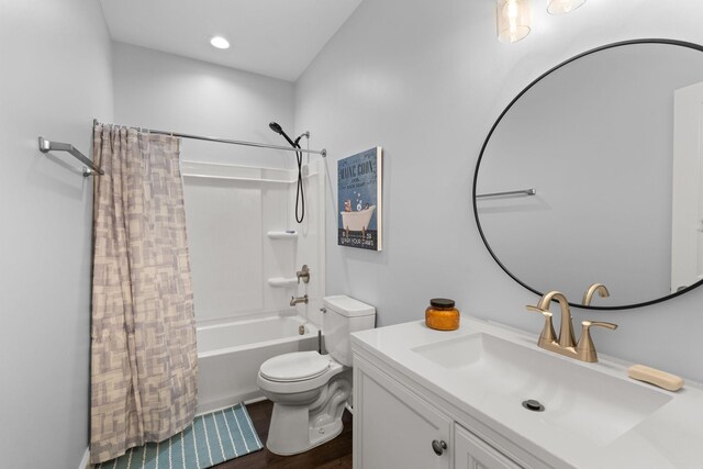 bathroom featuring shower / bath combo with shower curtain, toilet, recessed lighting, wood finished floors, and vanity