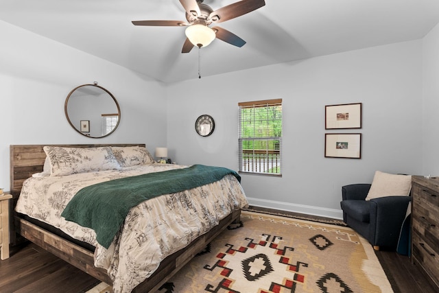 bedroom with baseboards, wood finished floors, and ceiling fan