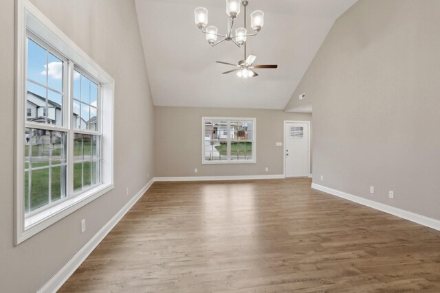 unfurnished living room with baseboards, wood finished floors, and plenty of natural light