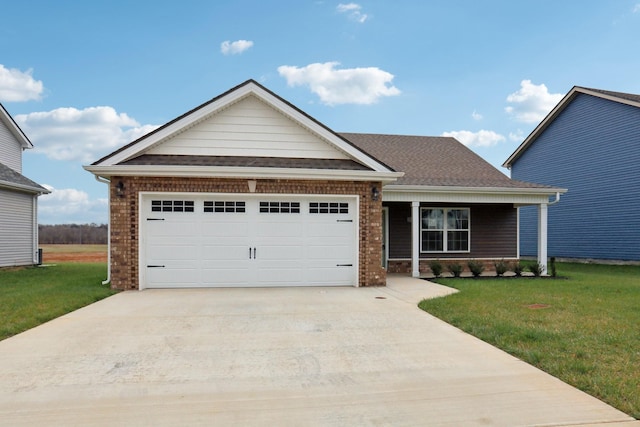 view of front of home featuring concrete driveway, a front yard, a shingled roof, and a garage