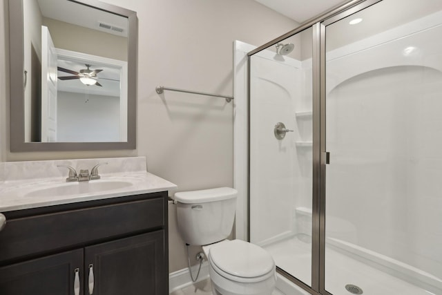 full bath with a shower stall, vanity, ceiling fan, toilet, and visible vents
