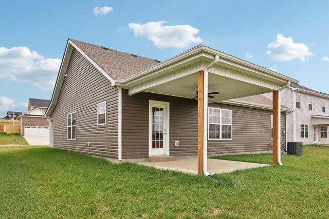 rear view of house featuring a lawn, a ceiling fan, central air condition unit, and a patio area