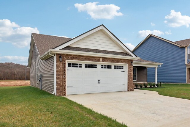 craftsman inspired home featuring driveway, a front lawn, a shingled roof, and an attached garage