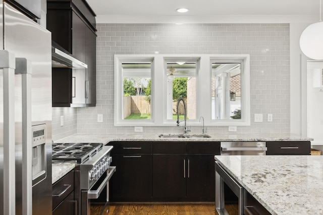 kitchen featuring ornamental molding, a ceiling fan, a sink, and stainless steel appliances