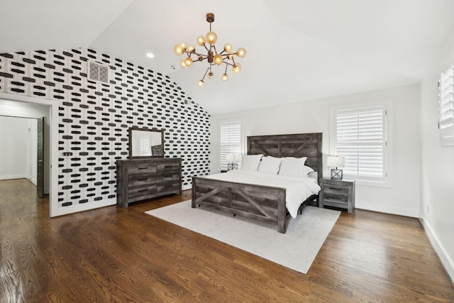 bedroom featuring an inviting chandelier, lofted ceiling, visible vents, baseboards, and wood finished floors