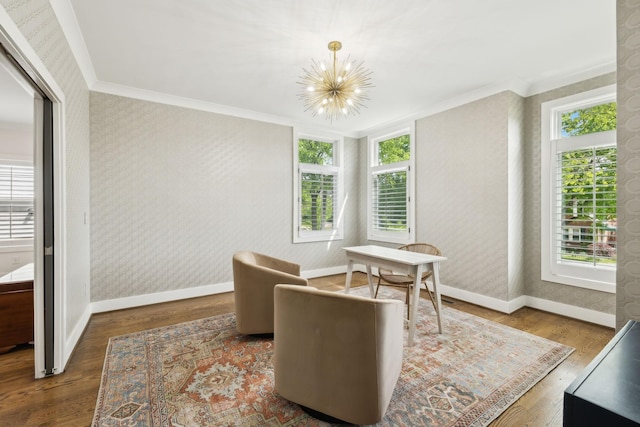sitting room featuring baseboards, wallpapered walls, ornamental molding, and a chandelier