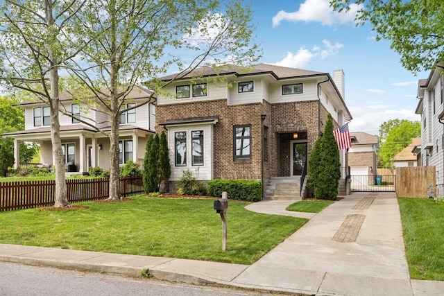 view of front of house featuring a front yard, brick siding, a gate, a chimney, and fence