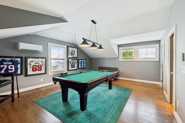 recreation room with lofted ceiling, wood finished floors, a healthy amount of sunlight, and an AC wall unit