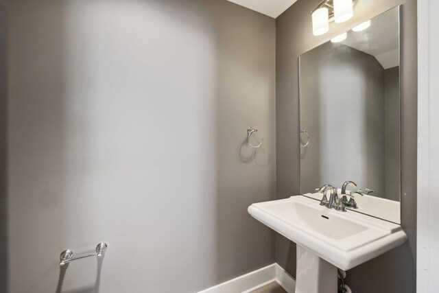 bathroom with baseboards and a sink