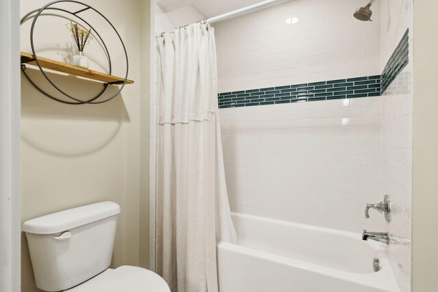 bathroom with shower / bath combination with curtain and toilet