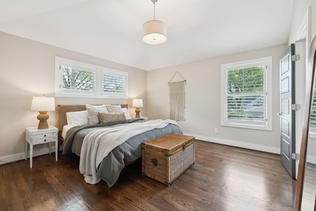 bedroom featuring baseboards and dark wood-type flooring