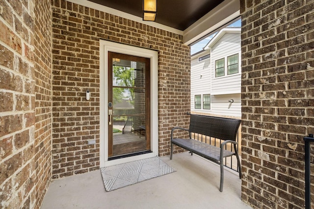 property entrance featuring brick siding