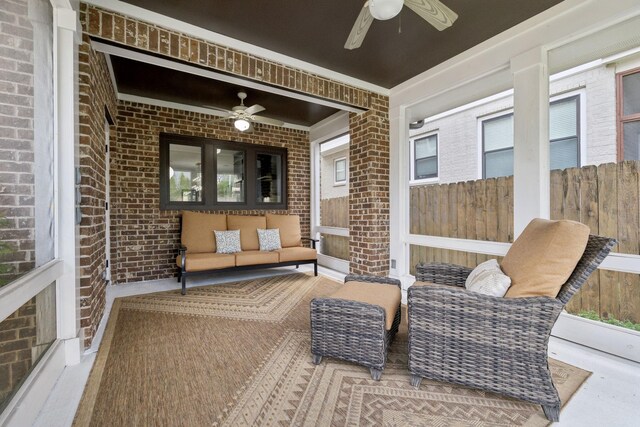 sunroom / solarium featuring a ceiling fan and outdoor lounge area