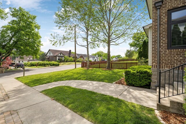 view of yard featuring fence and a residential view