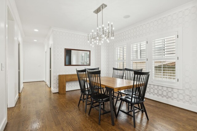 dining space with baseboards, wallpapered walls, ornamental molding, and a chandelier
