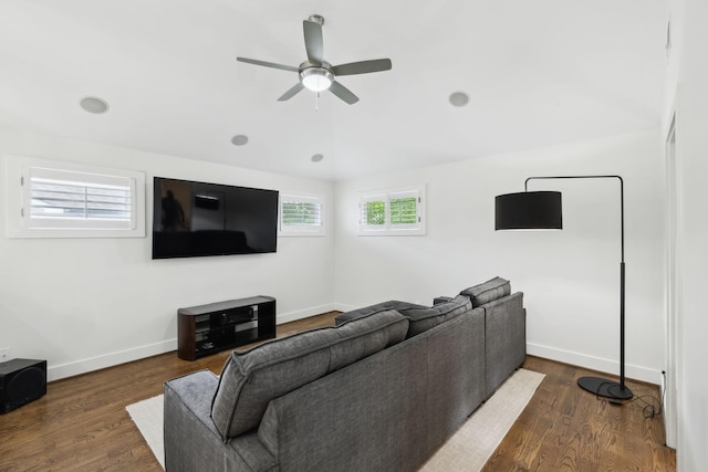 living area featuring dark wood-style floors, ceiling fan, lofted ceiling, and baseboards