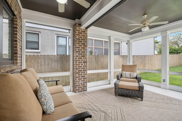 sunroom / solarium featuring ceiling fan