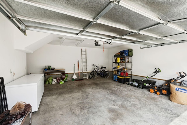 garage with a garage door opener and refrigerator