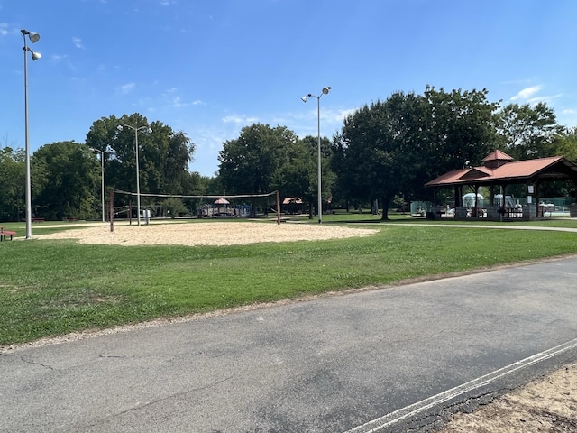 view of property's community featuring a gazebo, volleyball court, and a lawn
