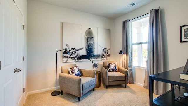 sitting room with visible vents, carpet flooring, and baseboards