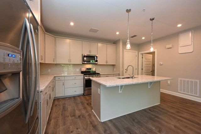 141 Saundersville Rd Unit 1305, Hendersonville, TN 37075 - kitchen with a sink, stainless steel appliances, a center island with sink, visible vents, and light stone counters