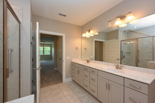 141 Saundersville Rd Unit 1305, Hendersonville, TN 37075 - bathroom with double vanity, visible vents, a stall shower, and a sink