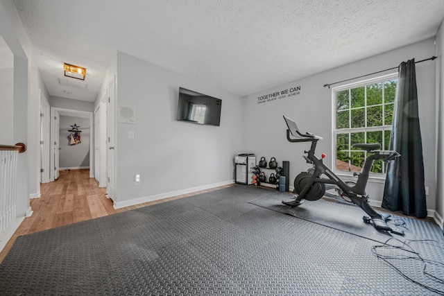 2011 Mccrory Pl, Spring Hill, TN 37174 - exercise area featuring baseboards, light wood-type flooring, and a textured ceiling