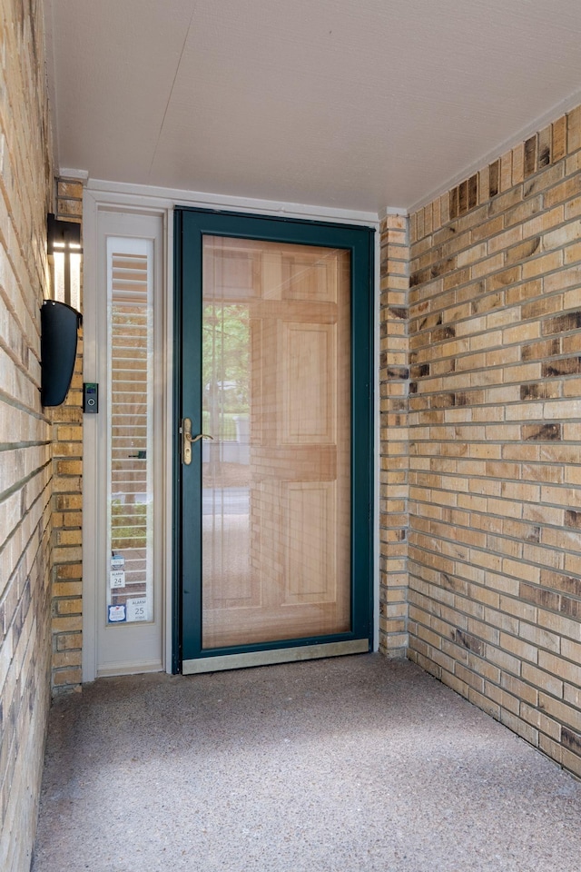 property entrance with brick siding