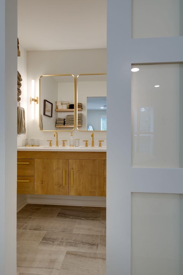 full bath featuring double vanity and a sink