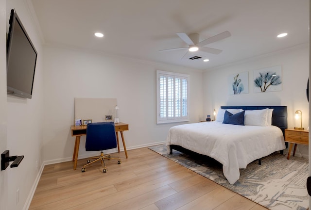 bedroom featuring visible vents, ornamental molding, and light wood-style floors