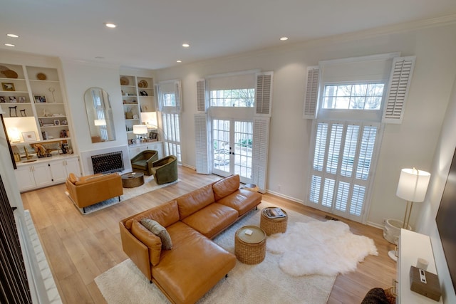 living room featuring ornamental molding, light wood finished floors, and recessed lighting