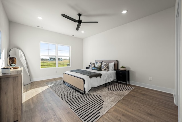 bedroom with recessed lighting, ceiling fan, visible vents, baseboards, and wood finished floors