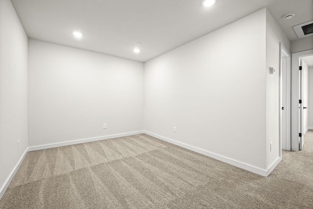 carpeted empty room featuring baseboards, recessed lighting, and visible vents