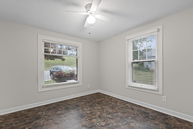 empty room with a textured ceiling, visible vents, baseboards, and plenty of natural light