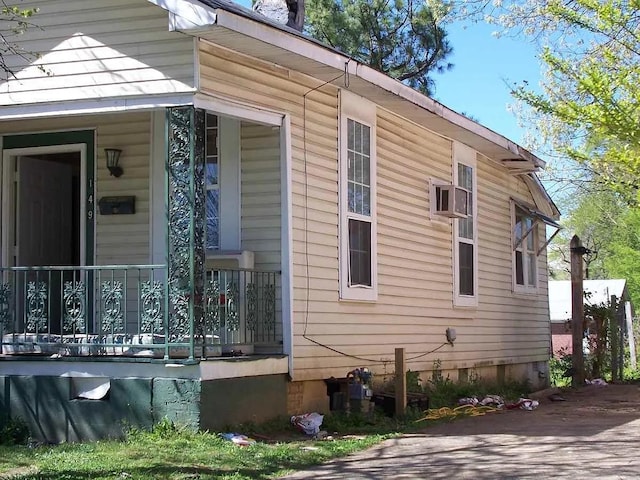 view of property exterior with covered porch