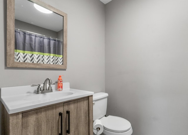 bathroom with vanity, toilet, and a shower with curtain