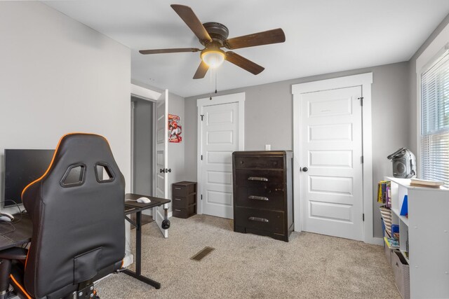 home office featuring carpet and a ceiling fan