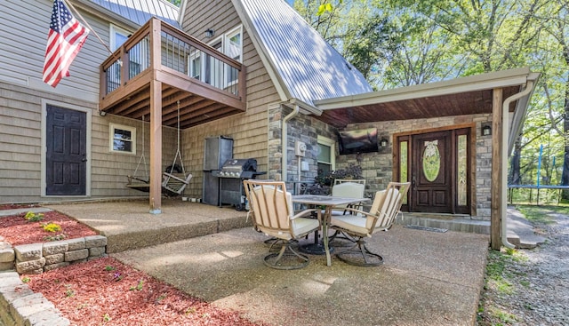 view of patio / terrace featuring outdoor dining area, grilling area, and a balcony