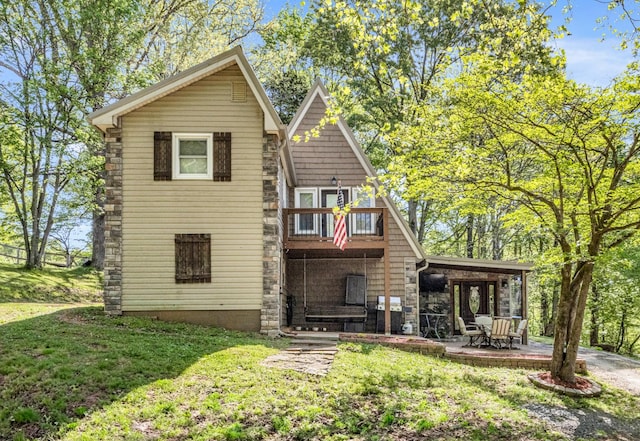 rear view of house featuring a patio and a yard