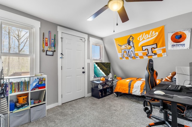 home office featuring carpet flooring, ceiling fan, and baseboards