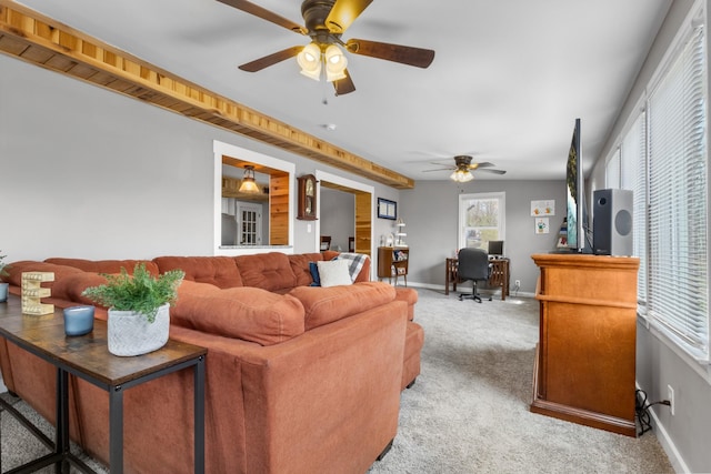 living room featuring light colored carpet, a ceiling fan, and baseboards