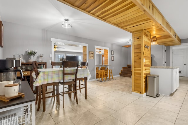 dining area featuring stairs