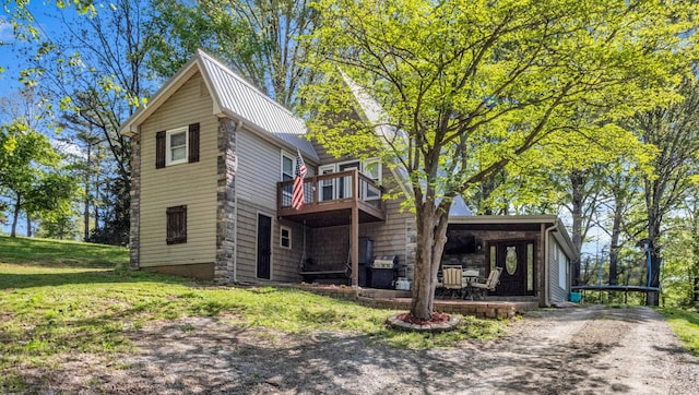 exterior space featuring log exterior, a yard, and metal roof