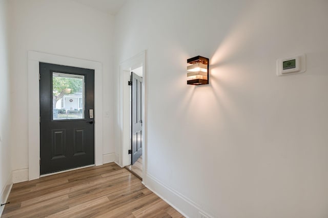 foyer featuring light wood-type flooring and baseboards