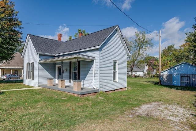 exterior space with a chimney, a porch, a shingled roof, and a lawn