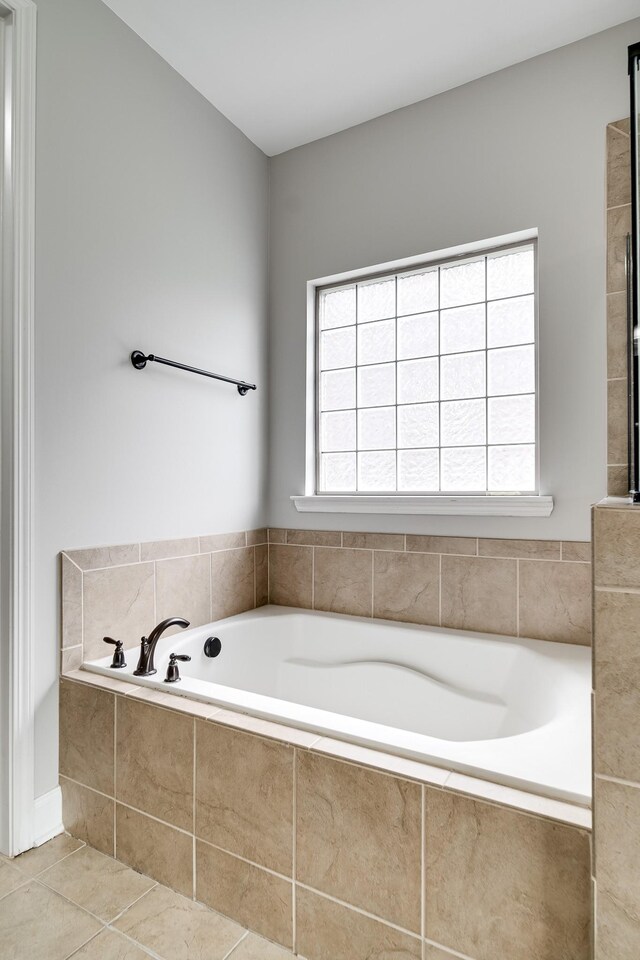 230 Fowler Cir, Franklin, TN 37064 - bathroom featuring tile patterned floors, a healthy amount of sunlight, and a garden tub